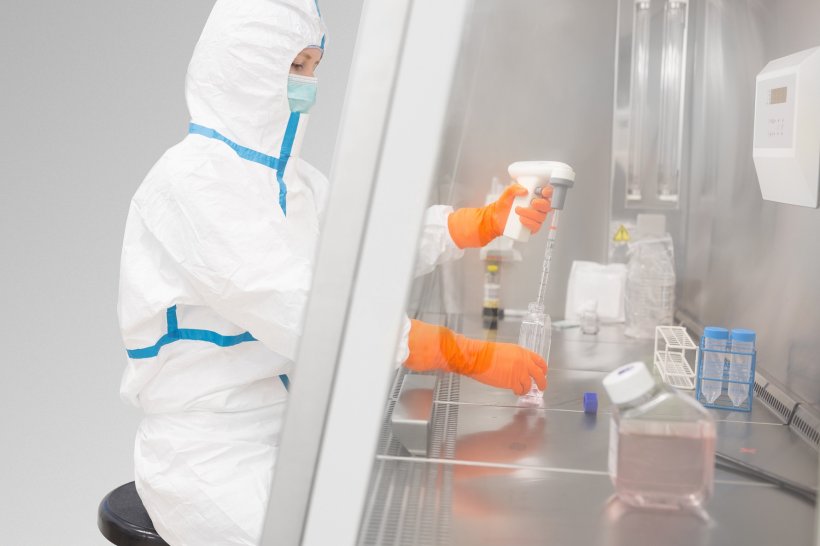 female laboratory worker in safety suit